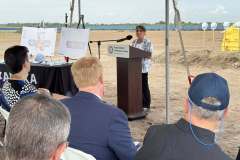 a woman speaks at the lectern during the ground breaking ceremony for Rye Ranch Elementary School in Parrish Florida