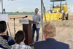 a gentleman in jeans and a sport coat speaks at the lectern during the ground breaking ceremony for Rye Ranch Elementary School in Parrish Florida