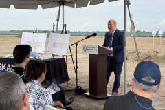 a gentleman in a suit speaks at the lectern during the ground breaking ceremony for Rye Ranch Elementary School in Parrish Florida