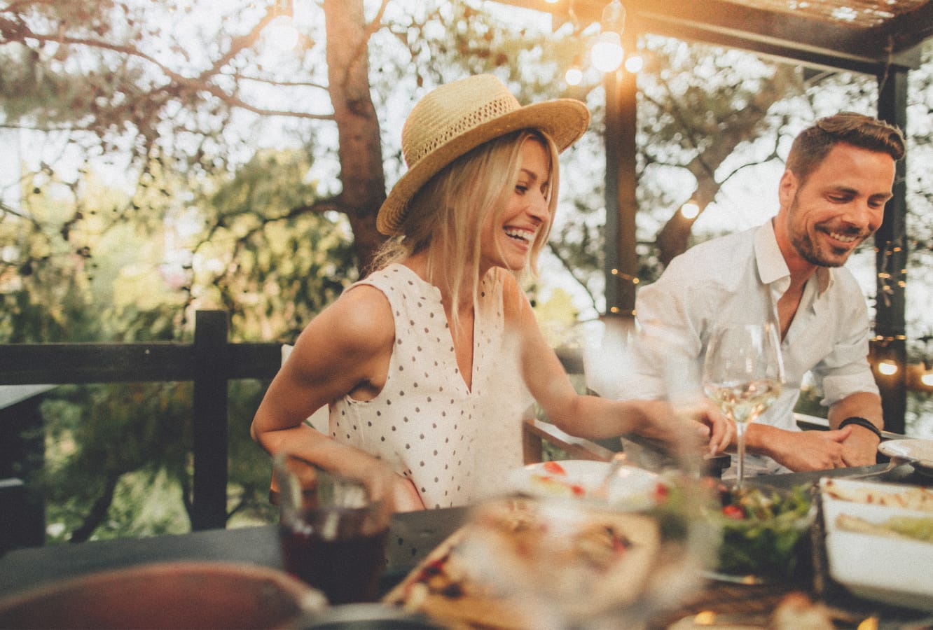 A couple sitting outdoors at a dinner party