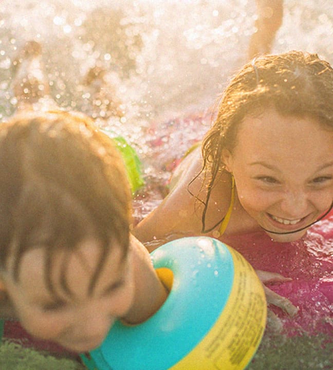 Kids splashing in a pool at Rye Ranch