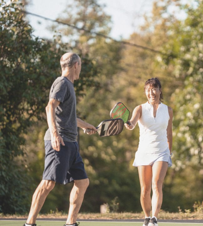 A couple playing pickleball at Rye Ranch