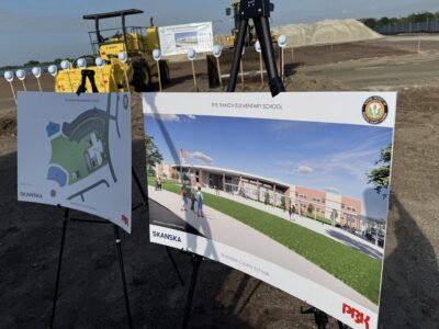 two poster boards of Rye Ranch Elementary School renderings are shown at the ground breaking event in Parrish Florida
