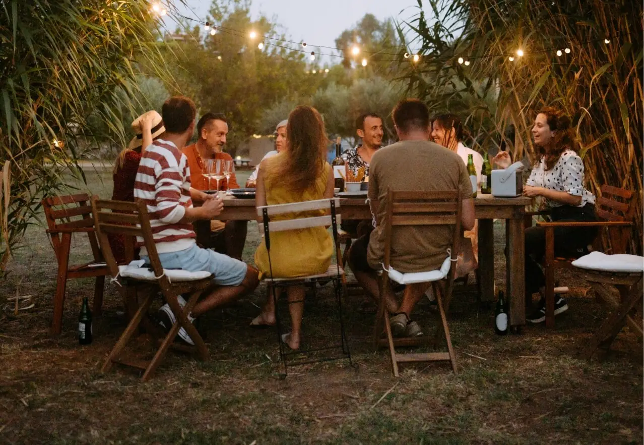 friends sitting at an outdoor table eating dinner